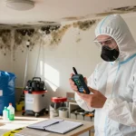Mold Remediation West Vancouver technician inspecting moisture levels in home